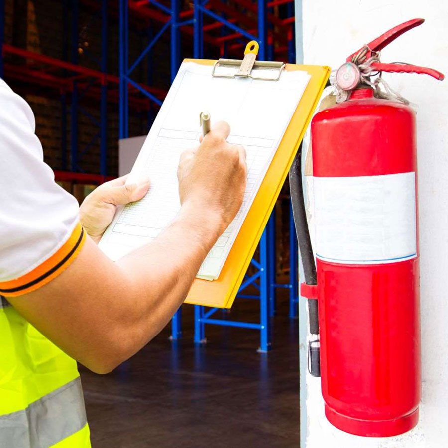 Fire safety audit team conducting inspection and handing over compliance report