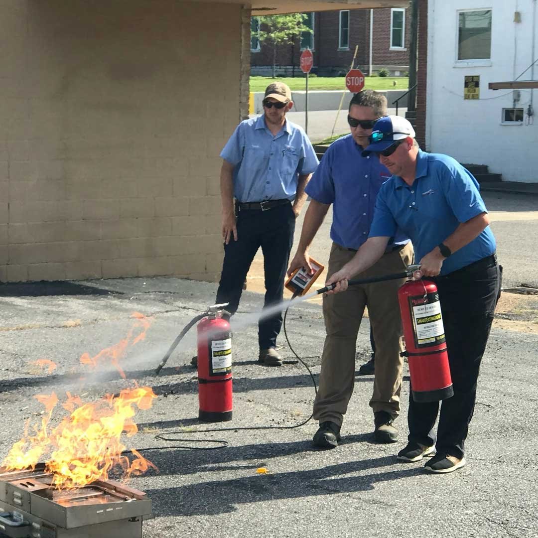Certified fire safety trainers with training materials and certificates.